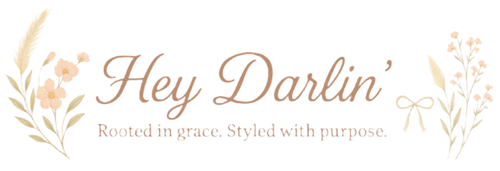 Logo for 'Hey Darlin'' with floral elements on a white background