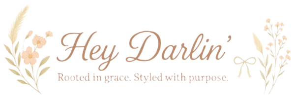 Logo for 'Hey Darlin'' with floral elements on a white background